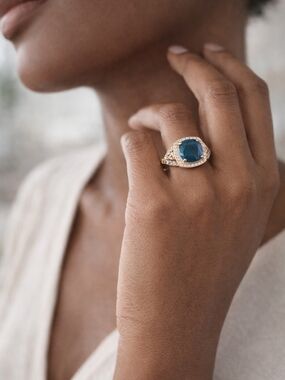 Gold Ring with Deep Blue Cushion Gem and Halo Accent